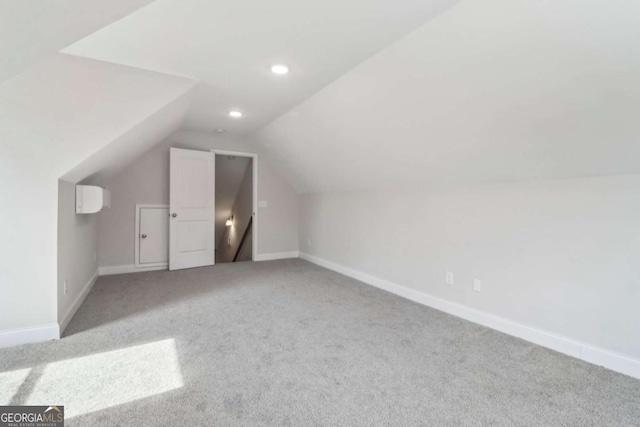 additional living space featuring lofted ceiling, recessed lighting, carpet flooring, and baseboards