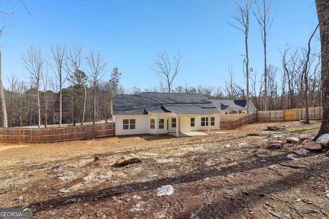 view of front facade with a fenced backyard and a patio