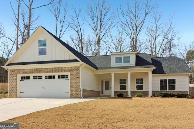 view of front of property featuring driveway, an attached garage, a front lawn, board and batten siding, and brick siding