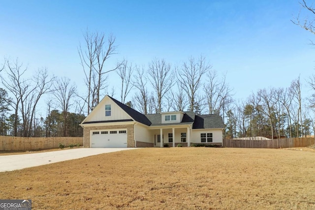 view of front of house with driveway, fence, a front lawn, and brick siding