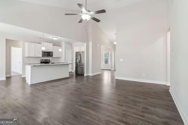 unfurnished living room featuring high vaulted ceiling, a ceiling fan, baseboards, and dark wood-style flooring