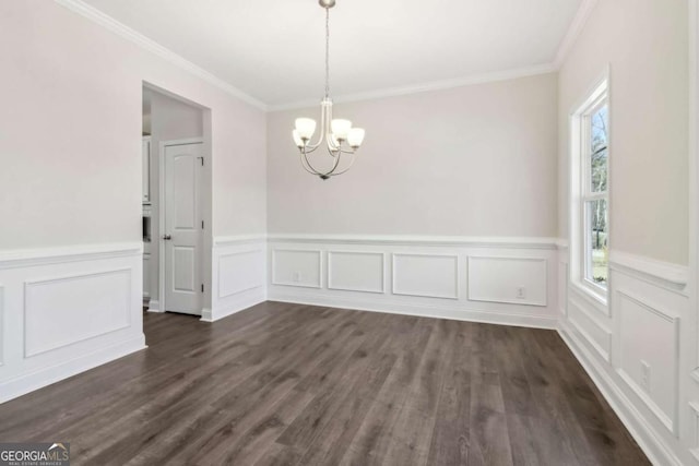 unfurnished dining area with ornamental molding, dark wood-type flooring, and an inviting chandelier