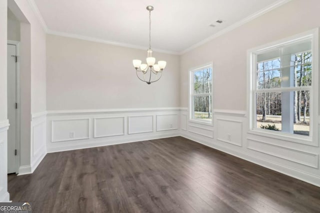 unfurnished dining area featuring crown molding, dark wood-style flooring, visible vents, and a notable chandelier