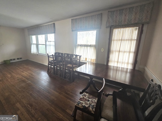 dining area featuring visible vents and wood finished floors