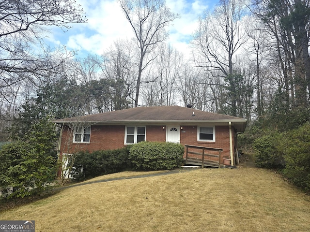 ranch-style house with a garage, brick siding, driveway, and a front lawn