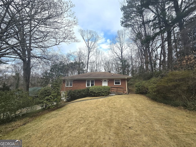 view of front of house featuring a front lawn and brick siding