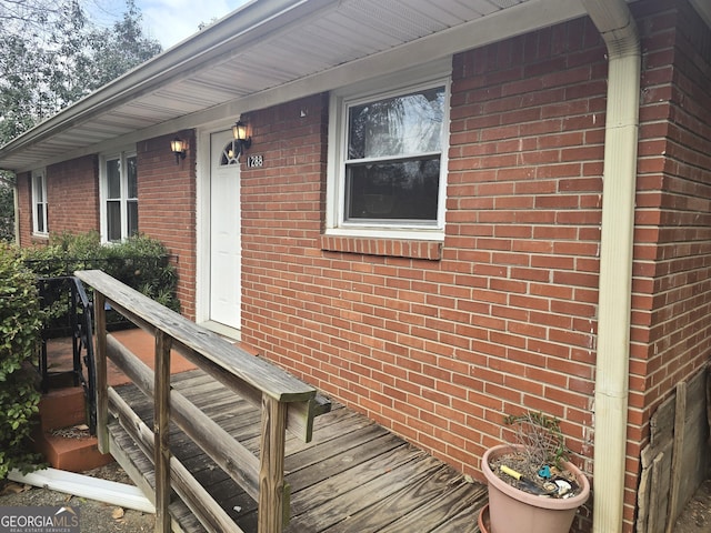 doorway to property featuring brick siding