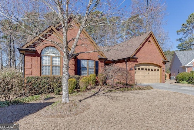 view of front of property with a garage, brick siding, driveway, and central AC unit