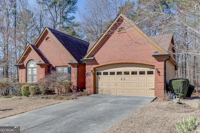 view of front facade featuring driveway, a garage, and brick siding