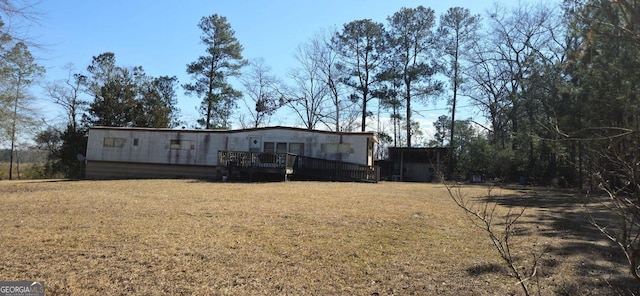 exterior space with a front lawn and a wooden deck