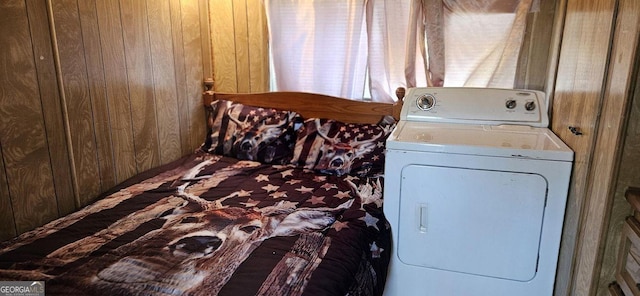 laundry area featuring laundry area, washer / clothes dryer, and wood walls