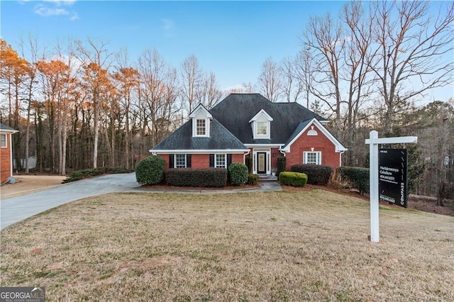 view of front of house with a front yard and brick siding