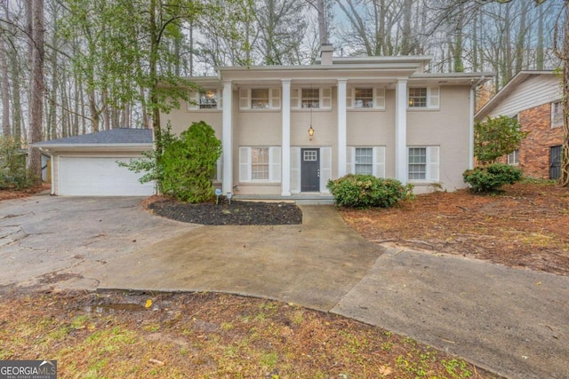 greek revival house with a detached garage