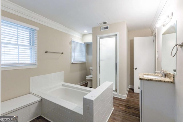 bathroom with toilet, wood finished floors, vanity, visible vents, and crown molding