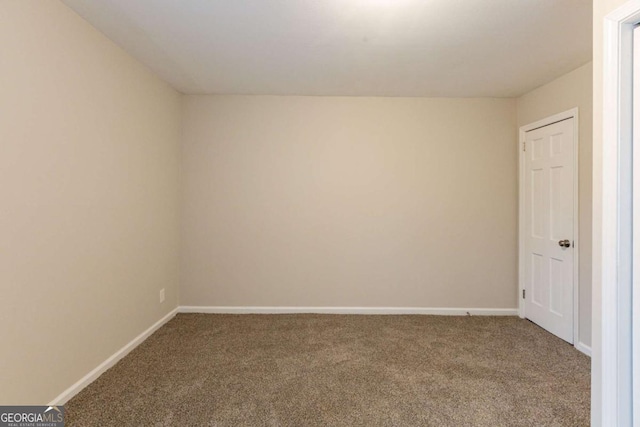 spare room with carpet and baseboards