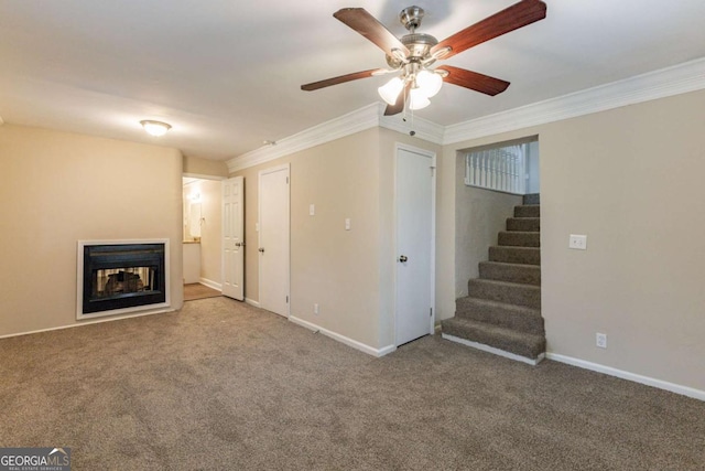 unfurnished living room featuring carpet flooring, a multi sided fireplace, baseboards, stairs, and ornamental molding