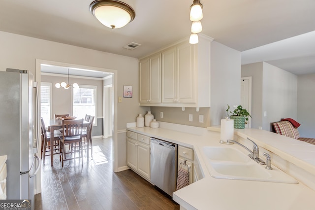 kitchen featuring stainless steel appliances, light countertops, and a sink