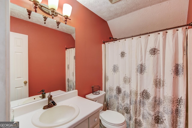 full bathroom featuring toilet, vaulted ceiling, a textured ceiling, and vanity