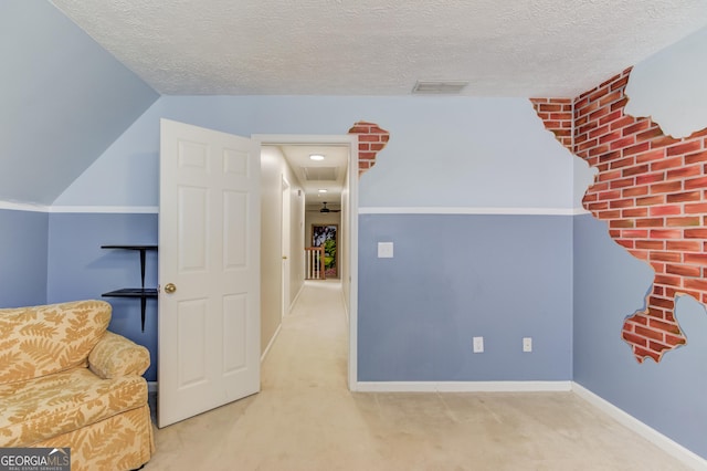 living area with a textured ceiling, carpet floors, visible vents, and baseboards