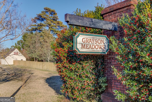 community / neighborhood sign with fence