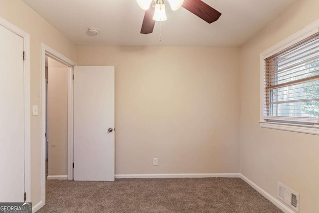 unfurnished bedroom with a ceiling fan, baseboards, visible vents, and carpet flooring