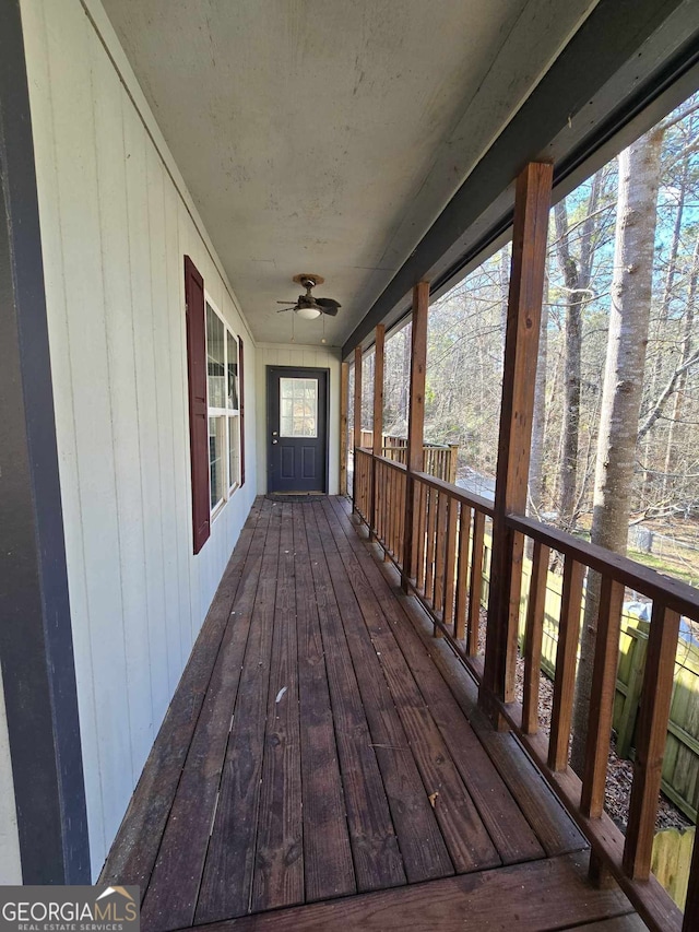 wooden terrace with a ceiling fan