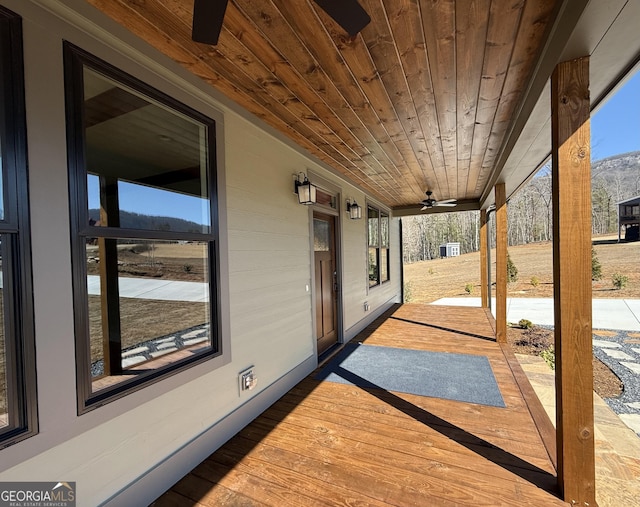 view of patio with ceiling fan and a mountain view