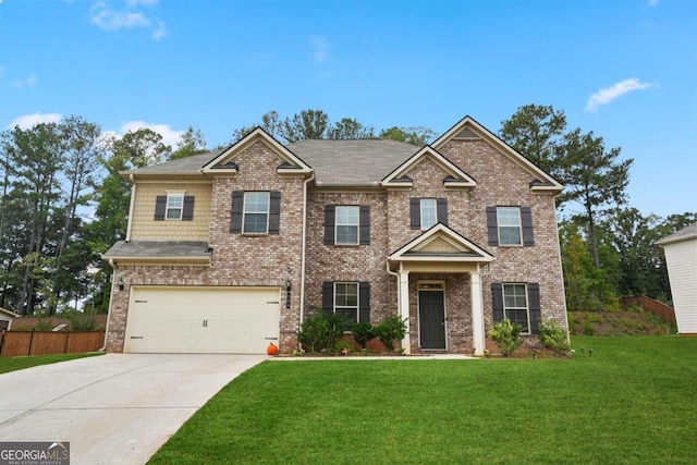 view of front of house with brick siding, driveway, a front lawn, and fence