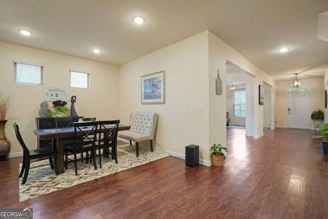 dining room with a healthy amount of sunlight, baseboards, wood finished floors, and recessed lighting