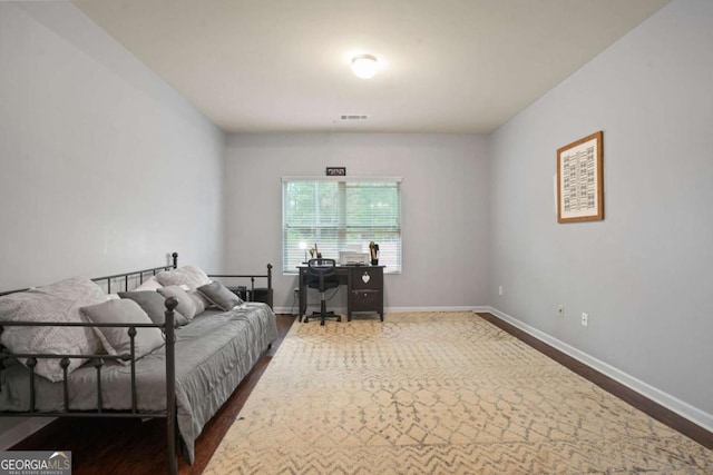 interior space with dark wood-style floors, visible vents, and baseboards