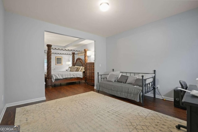 unfurnished bedroom with baseboards and dark wood-type flooring