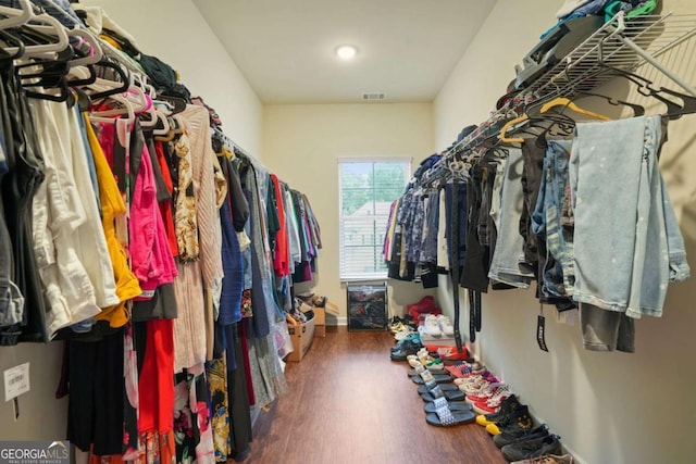 spacious closet with dark wood-type flooring and visible vents