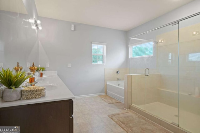 full bath with double vanity, a stall shower, a sink, baseboards, and a bath