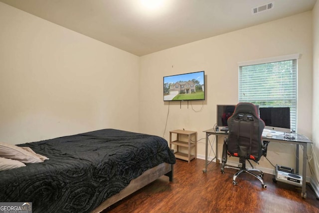 bedroom featuring dark wood-style floors, visible vents, and baseboards