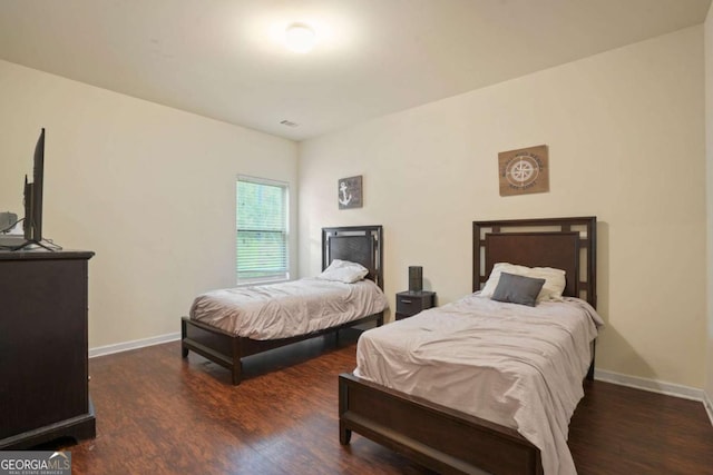 bedroom featuring dark wood-style floors and baseboards