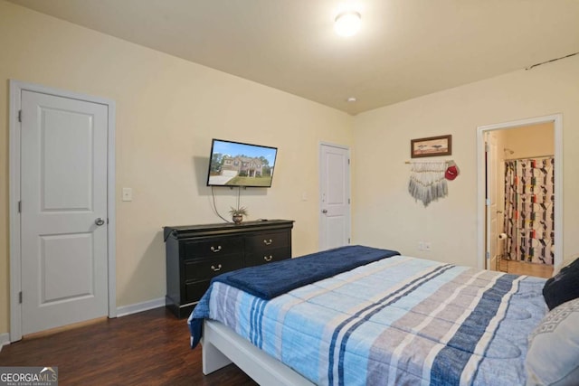 bedroom with dark wood-style flooring and baseboards