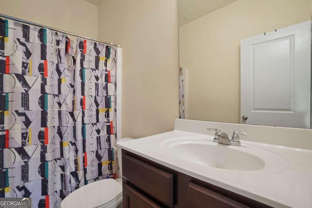 bathroom featuring vanity and toilet