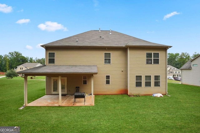 rear view of property featuring a patio area and a yard