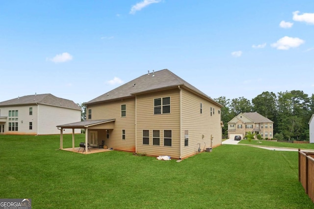 rear view of house featuring a yard and a patio area