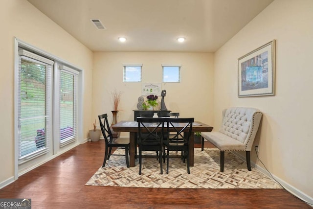 dining room featuring baseboards, visible vents, wood finished floors, and recessed lighting