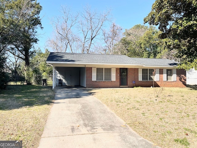 ranch-style house with an attached carport, brick siding, driveway, and a front lawn