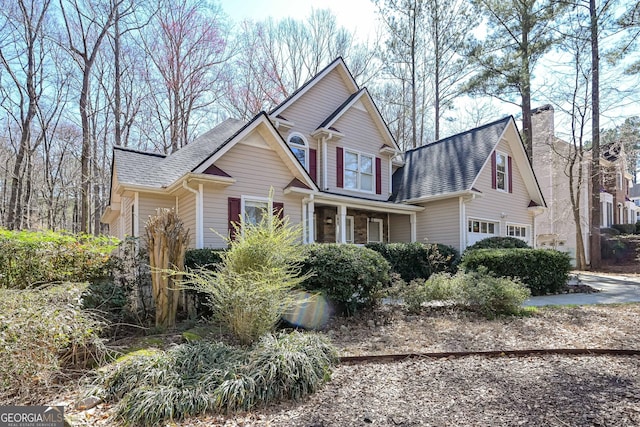 view of front of property with a chimney and a shingled roof