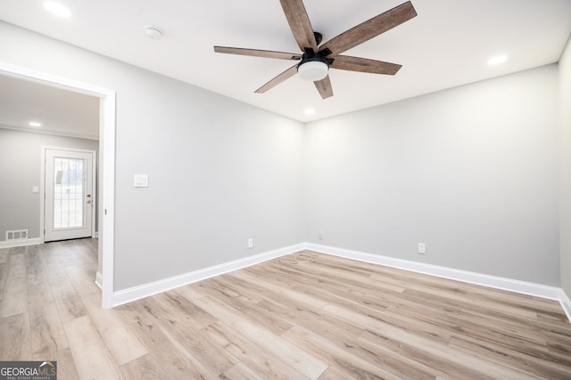 spare room with light wood-type flooring, visible vents, baseboards, and recessed lighting