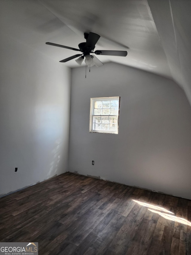 interior space with dark wood-style floors, vaulted ceiling, and a ceiling fan