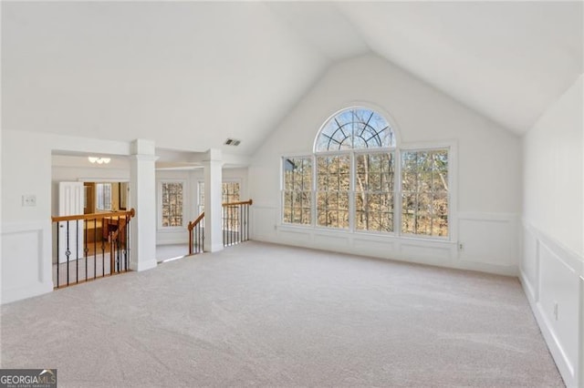 3690 Millwater Xing, Dacula, GA 30019 - unfurnished living room with carpet flooring, vaulted ceiling, and ornate columns