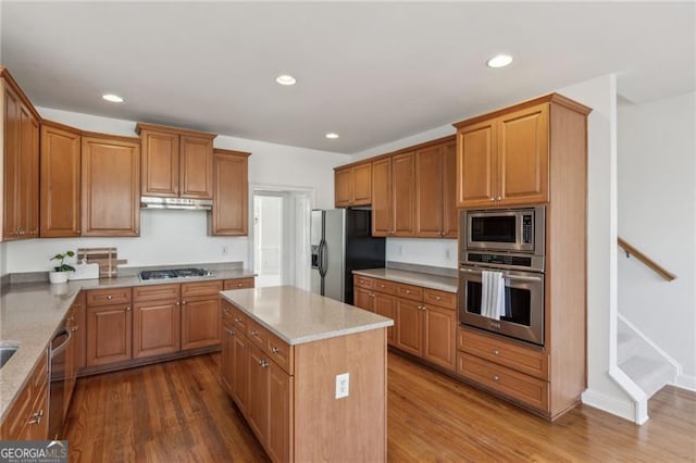 3690 Millwater Xing, Dacula, GA 30019 - kitchen featuring stainless steel appliances, under cabinet range hood, wood finished floors, a kitchen island, and recessed lighting