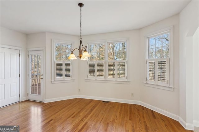 3690 Millwater Xing, Dacula, GA 30019 - unfurnished dining area featuring a chandelier and wood finished floors