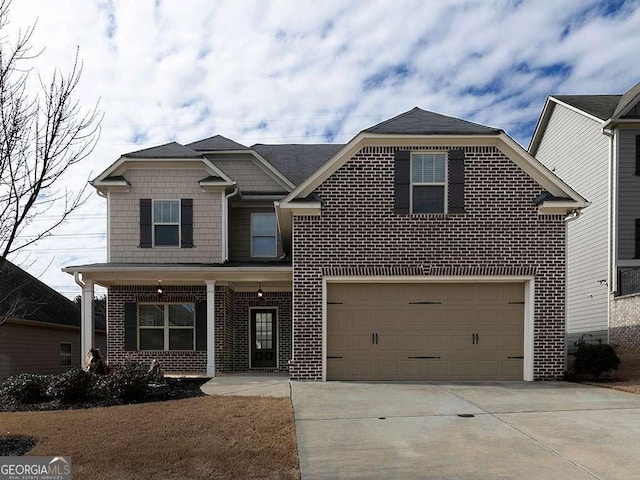 view of front of property featuring driveway, a garage, and brick siding