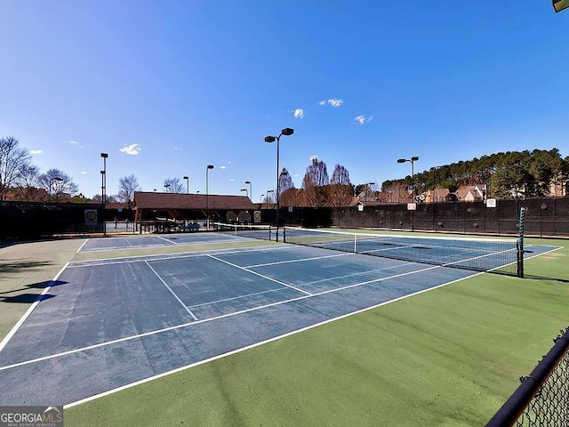 view of tennis court with fence