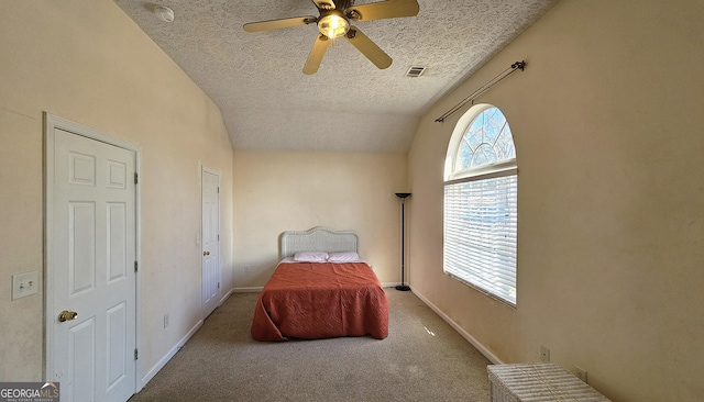 carpeted bedroom featuring lofted ceiling, visible vents, a textured ceiling, and baseboards